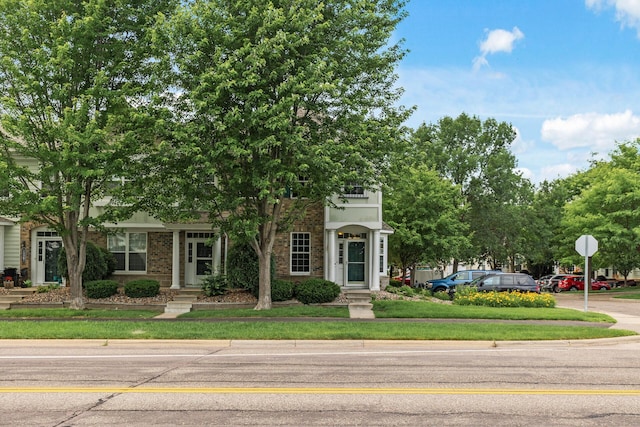 15359 Foliage Ave Unit 501, Apple Valley, MN 55124 - view of property hidden behind natural elements with a front lawn and brick siding