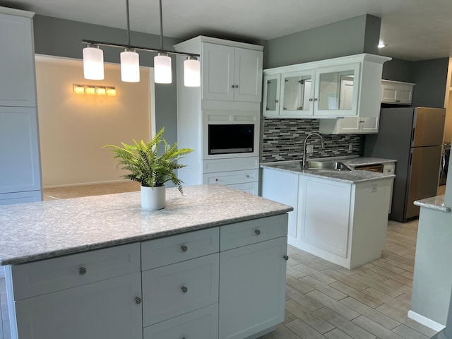 6563 Parkview Cir, Baxter, MN 56425 - kitchen featuring a sink, freestanding refrigerator, backsplash, white cabinetry, and recessed lighting