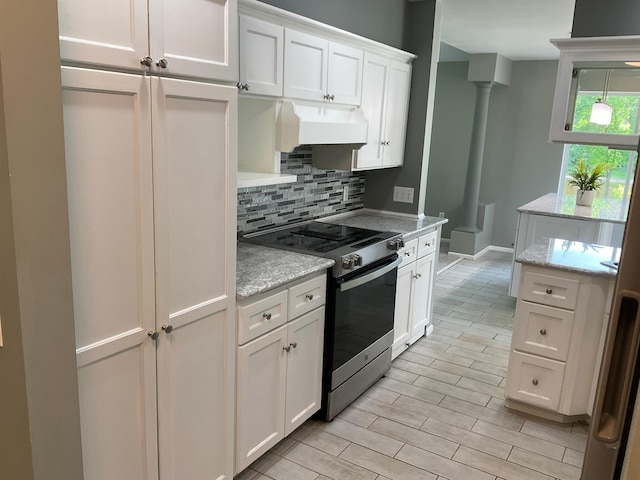 6563 Parkview Cir, Baxter, MN 56425 - kitchen featuring stainless steel electric range, under cabinet range hood, tasteful backsplash, white cabinets, and light wood-style flooring