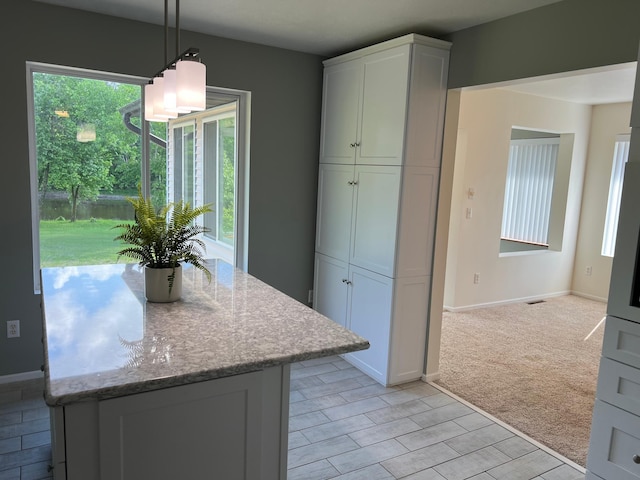 6563 Parkview Cir, Baxter, MN 56425 - kitchen with plenty of natural light, light stone counters, decorative light fixtures, and white cabinetry