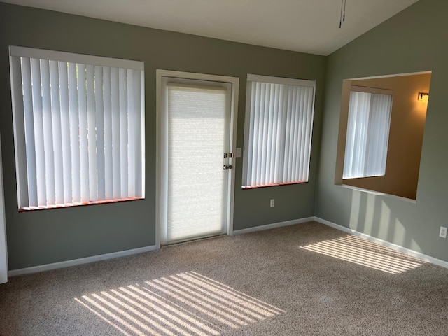 6563 Parkview Cir, Baxter, MN 56425 - empty room featuring carpet floors, healthy amount of natural light, baseboards, and vaulted ceiling