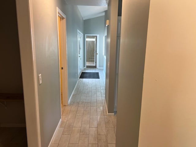 6563 Parkview Cir, Baxter, MN 56425 - hallway with wood tiled floors, baseboards, and lofted ceiling