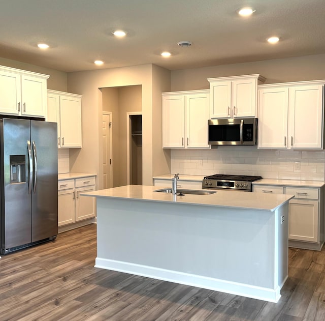 5022 Useppa Trl, Woodbury, MN 55129 - kitchen with appliances with stainless steel finishes, dark wood-type flooring, a sink, backsplash, and white cabinetry