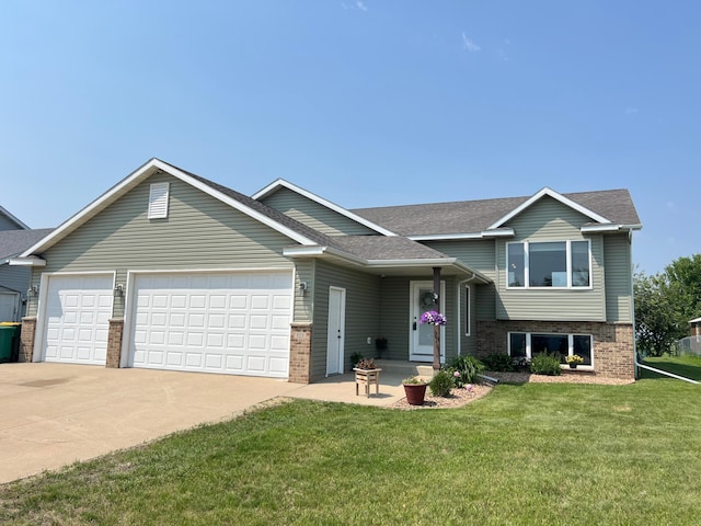823 4th St NE, Byron, MN 55920 - split level home featuring a garage, brick siding, driveway, and a front yard