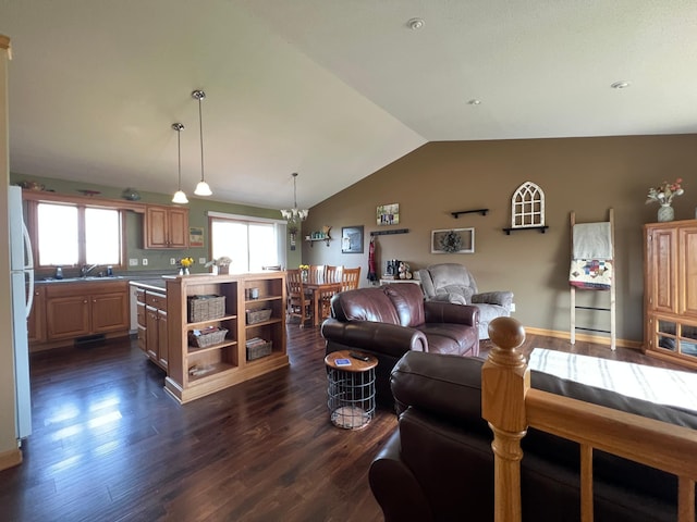 823 4th St NE, Byron, MN 55920 - living area featuring vaulted ceiling, dark wood-type flooring, and a chandelier