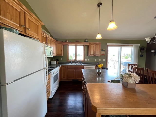 823 4th St NE, Byron, MN 55920 - kitchen featuring white appliances, a sink, dark wood finished floors, dark countertops, and decorative light fixtures