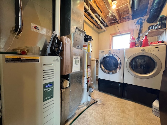 823 4th St NE, Byron, MN 55920 - laundry area featuring heating unit, washer and clothes dryer, gas water heater, and tile patterned flooring
