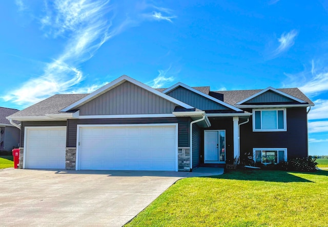 4201 Silver Ridge Pl NW, Rochester, MN 55901 - view of front of house with a garage, a front yard, concrete driveway, stone siding, and roof with shingles