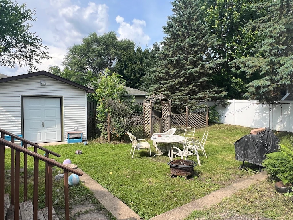 4121 2nd St NE, Columbia Heights, MN 55421 - view of yard with an outdoor fire pit and an outdoor structure