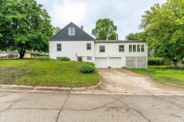327 Channing Ave, Fergus Falls, MN 56537 - view of property exterior with a garage, concrete driveway, a yard, and a chimney