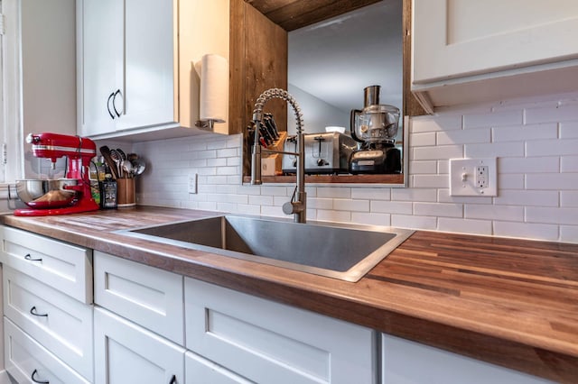 327 Channing Ave, Fergus Falls, MN 56537 - kitchen featuring a sink, white cabinetry, decorative backsplash, and wood counters