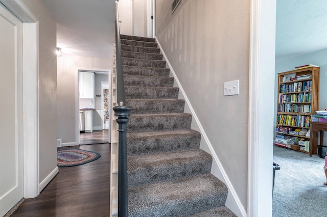 327 Channing Ave, Fergus Falls, MN 56537 - staircase featuring baseboards and wood finished floors