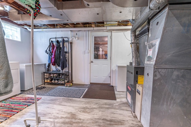 327 Channing Ave, Fergus Falls, MN 56537 - basement featuring fridge, washer and clothes dryer, wood finished floors, and heating unit