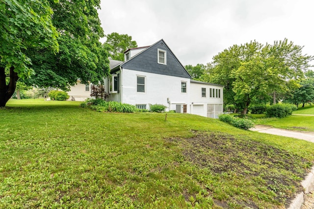 327 Channing Ave, Fergus Falls, MN 56537 - view of property exterior featuring an attached garage, concrete driveway, and a lawn