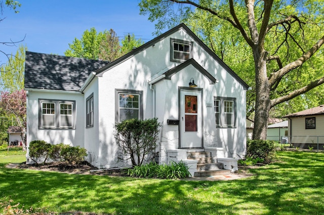 3017 32nd Ave NE, Saint Anthony, MN 55418 - view of front of property featuring a front lawn, stucco siding, a shingled roof, and entry steps