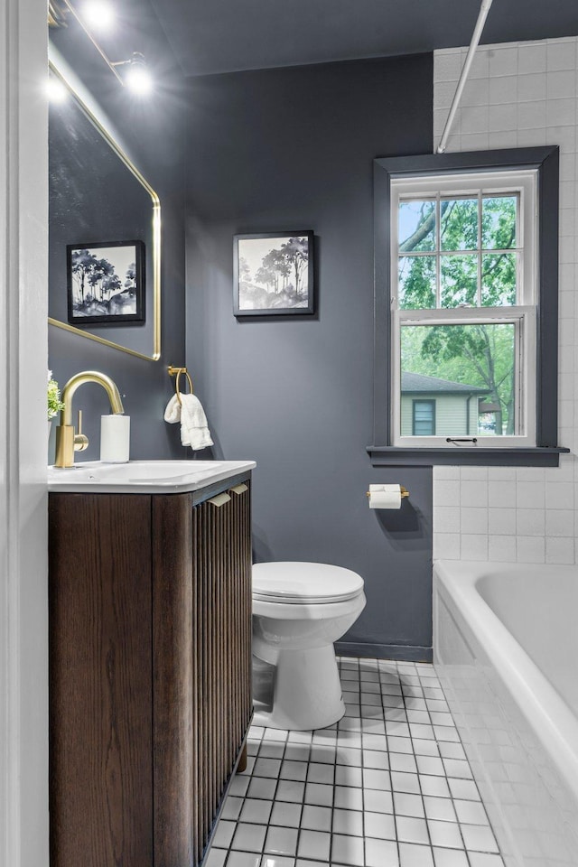 3017 32nd Ave NE, Saint Anthony, MN 55418 - full bathroom featuring tile patterned floors, a bathtub, and vanity