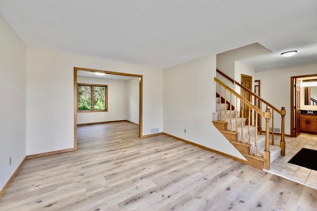 7158 Deerwood Ln N, Maple Grove, MN 55369 - unfurnished living room with light wood finished floors and stairs