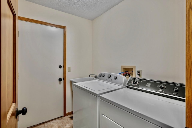 7158 Deerwood Ln N, Maple Grove, MN 55369 - laundry area featuring washing machine and dryer and a textured ceiling