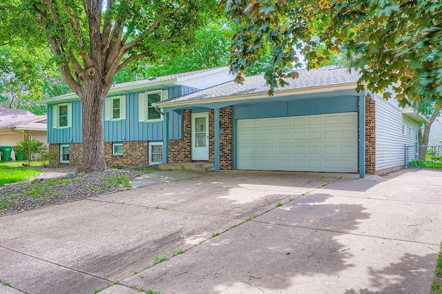 10465 Osage St NW, Coon Rapids, MN 55433 - tri-level home with board and batten siding, an attached garage, driveway, and brick siding