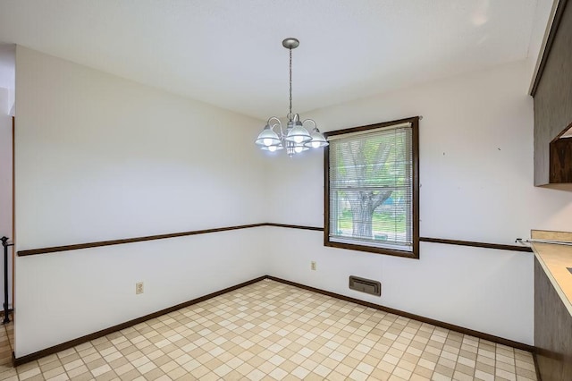 10465 Osage St NW, Coon Rapids, MN 55433 - unfurnished dining area featuring a chandelier and baseboards