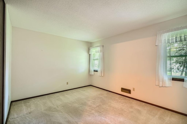 10465 Osage St NW, Coon Rapids, MN 55433 - carpeted empty room featuring a textured ceiling and baseboards