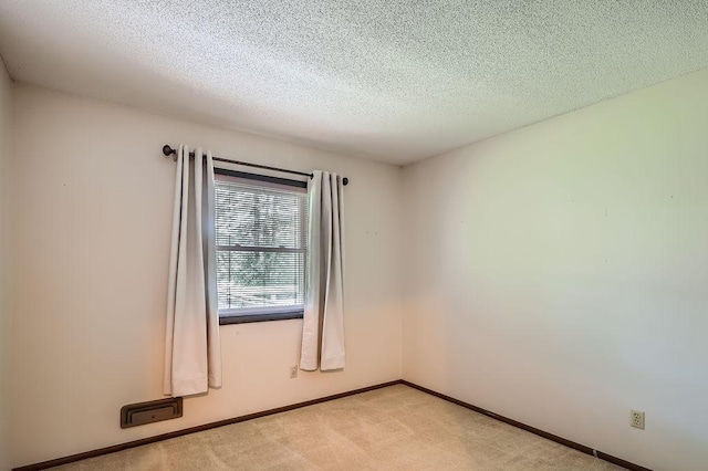 10465 Osage St NW, Coon Rapids, MN 55433 - spare room featuring light colored carpet and a textured ceiling