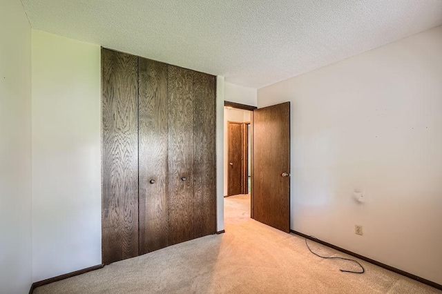 10465 Osage St NW, Coon Rapids, MN 55433 - unfurnished bedroom with carpet, a closet, and a textured ceiling