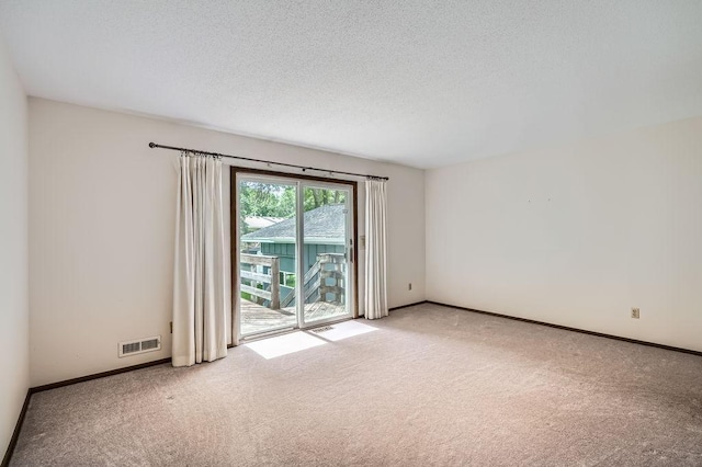 10465 Osage St NW, Coon Rapids, MN 55433 - carpeted empty room featuring a textured ceiling and baseboards