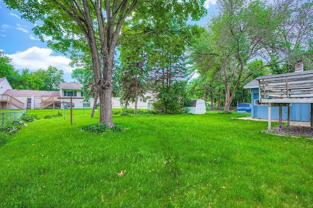 10465 Osage St NW, Coon Rapids, MN 55433 - view of yard featuring a shed and a wooden deck