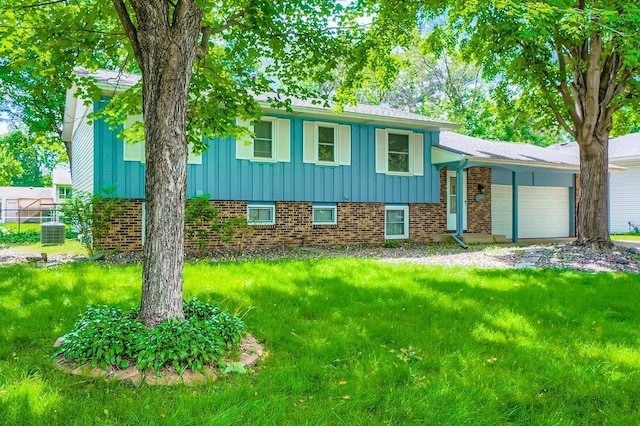 10465 Osage St NW, Coon Rapids, MN 55433 - split level home with board and batten siding, a garage, brick siding, and a front yard