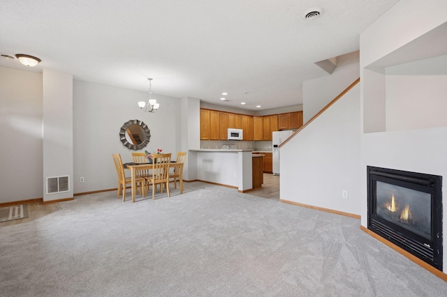 10612 172nd Ln NW, Elk River, MN 55330 - living room with light carpet, baseboards, a chandelier, recessed lighting, and a glass covered fireplace