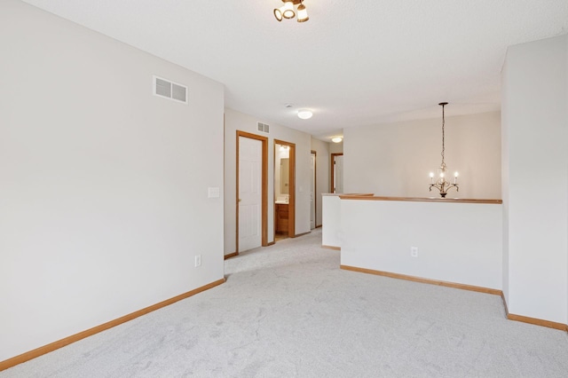 10612 172nd Ln NW, Elk River, MN 55330 - unfurnished room with light carpet, a chandelier, and baseboards