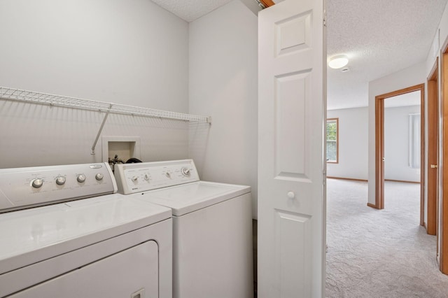 10612 172nd Ln NW, Elk River, MN 55330 - laundry room featuring independent washer and dryer, light colored carpet, and a textured ceiling