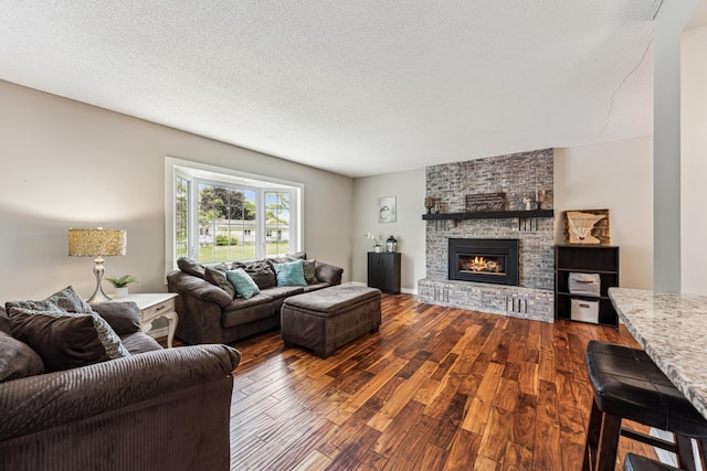 11788 65th Pl N, Maple Grove, MN 55369 - living room featuring dark wood finished floors, a brick fireplace, and a textured ceiling