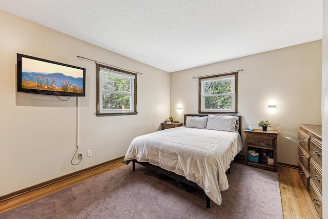 11788 65th Pl N, Maple Grove, MN 55369 - bedroom featuring wood finished floors, multiple windows, a textured ceiling, and baseboards