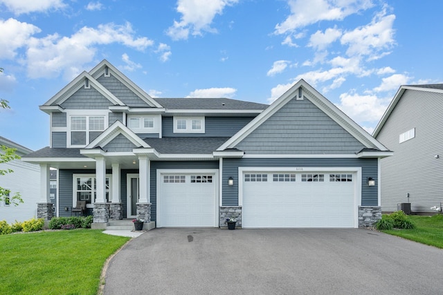 6016 Inskip Ave S, Cottage Grove, MN 55016 - craftsman inspired home with asphalt driveway, stone siding, an attached garage, and a front yard