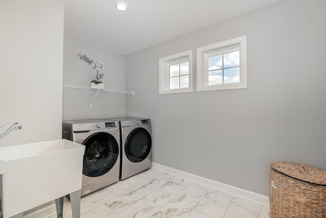6016 Inskip Ave S, Cottage Grove, MN 55016 - laundry room featuring washer and clothes dryer, light marble finish floors, baseboards, and a textured ceiling