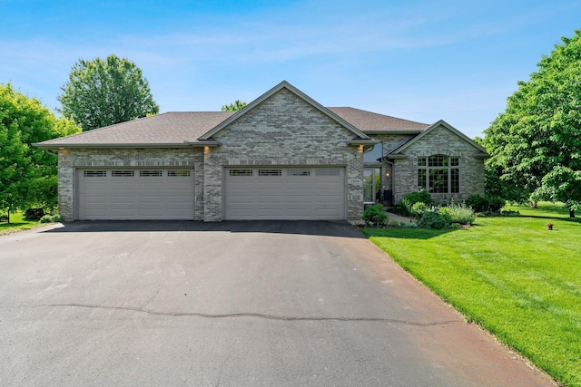 2554 160th Ave NE, Ham Lake, MN 55304 - view of front facade featuring driveway, a front lawn, a garage, roof with shingles, and brick siding