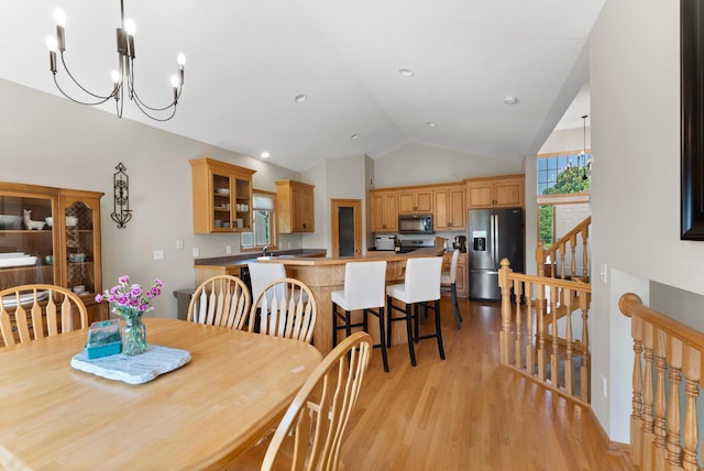 2554 160th Ave NE, Ham Lake, MN 55304 - dining area with a chandelier, light wood-style flooring, and high vaulted ceiling