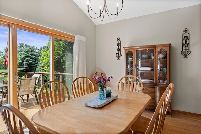 2554 160th Ave NE, Ham Lake, MN 55304 - dining area featuring vaulted ceiling, a chandelier, and wood finished floors