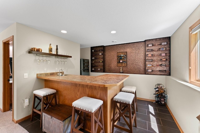 2554 160th Ave NE, Ham Lake, MN 55304 - indoor wet bar with dark tile patterned floors, recessed lighting, baseboards, and freestanding refrigerator