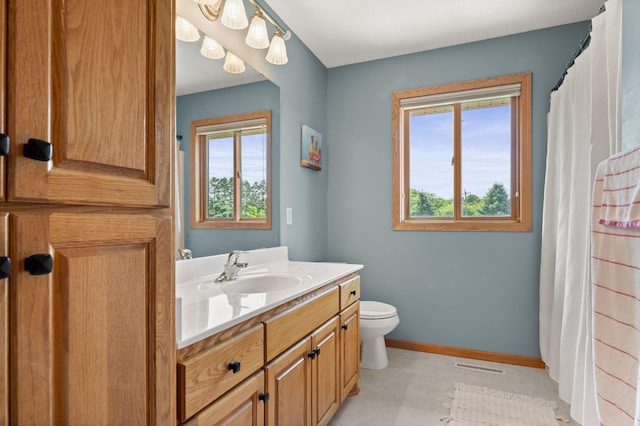 2554 160th Ave NE, Ham Lake, MN 55304 - full bathroom featuring vanity, toilet, baseboards, tile patterned flooring, and curtained shower