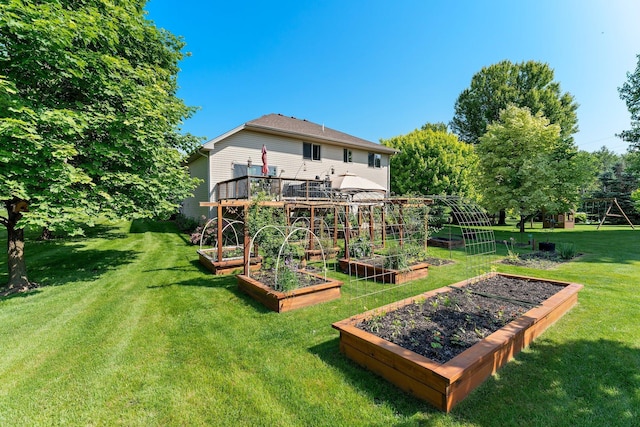 2554 160th Ave NE, Ham Lake, MN 55304 - view of green lawn with a vegetable garden and a wooden deck