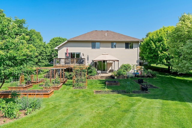 2554 160th Ave NE, Ham Lake, MN 55304 - back of house featuring a vegetable garden, a gazebo, a lawn, and a deck