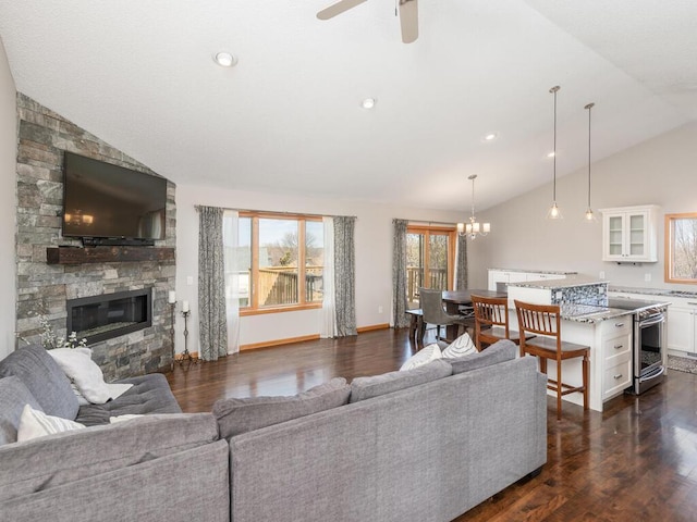 16850 Willowwood Cir SE, Prior Lake, MN 55372 - living room featuring lofted ceiling, dark wood-style flooring, a chandelier, a ceiling fan, and a fireplace