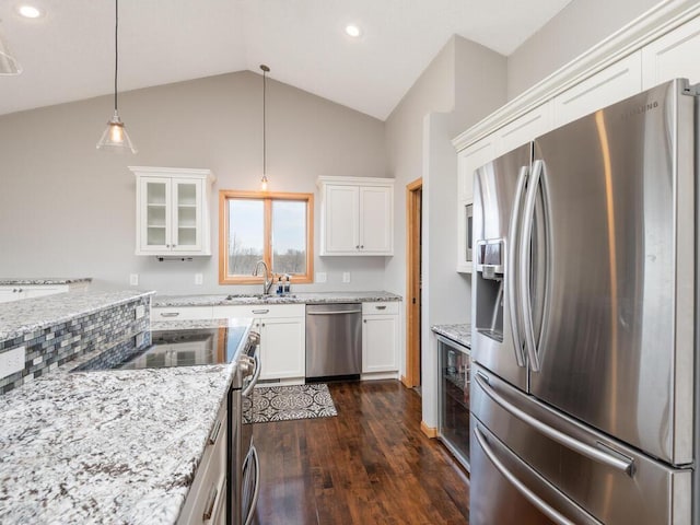16850 Willowwood Cir SE, Prior Lake, MN 55372 - kitchen with stainless steel appliances, a sink, white cabinetry, dark wood-style flooring, and vaulted ceiling