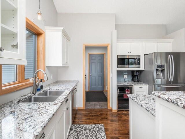 16850 Willowwood Cir SE, Prior Lake, MN 55372 - kitchen with stainless steel appliances, beverage cooler, a sink, dark wood finished floors, and white cabinetry
