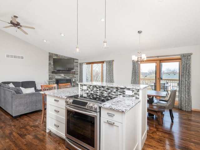 16850 Willowwood Cir SE, Prior Lake, MN 55372 - kitchen featuring stainless steel range with electric stovetop, lofted ceiling, open floor plan, ceiling fan, and a chandelier