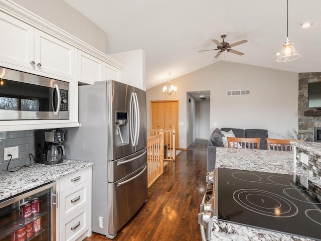 16850 Willowwood Cir SE, Prior Lake, MN 55372 - kitchen featuring stainless steel appliances, open floor plan, beverage cooler, lofted ceiling, and ceiling fan