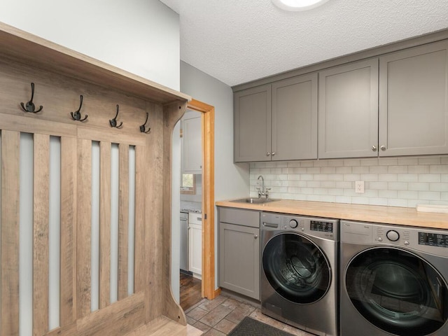 16850 Willowwood Cir SE, Prior Lake, MN 55372 - washroom with independent washer and dryer, cabinet space, and a textured ceiling